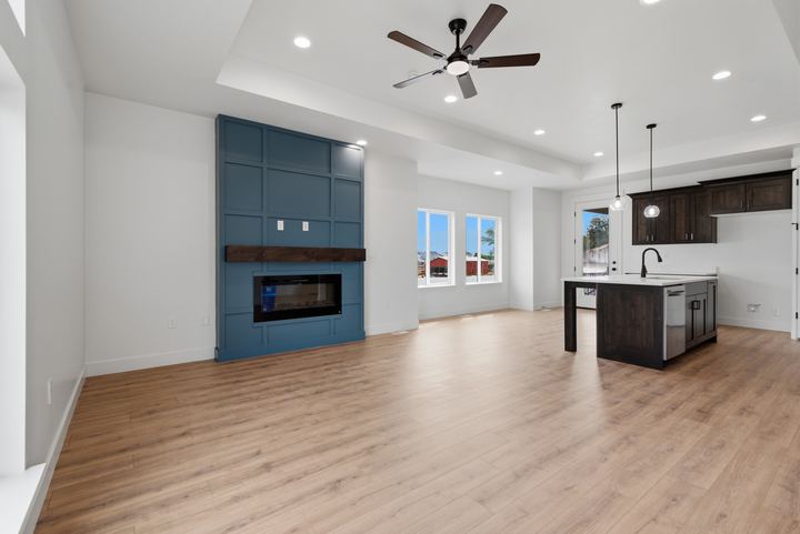 Isom Estates great room with blue paneled fireplace