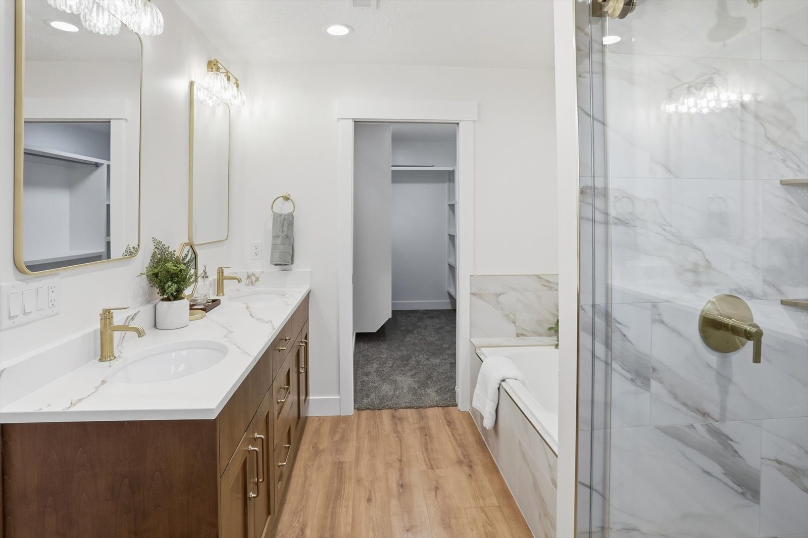 Primary bath with marble shower and walk-in closet