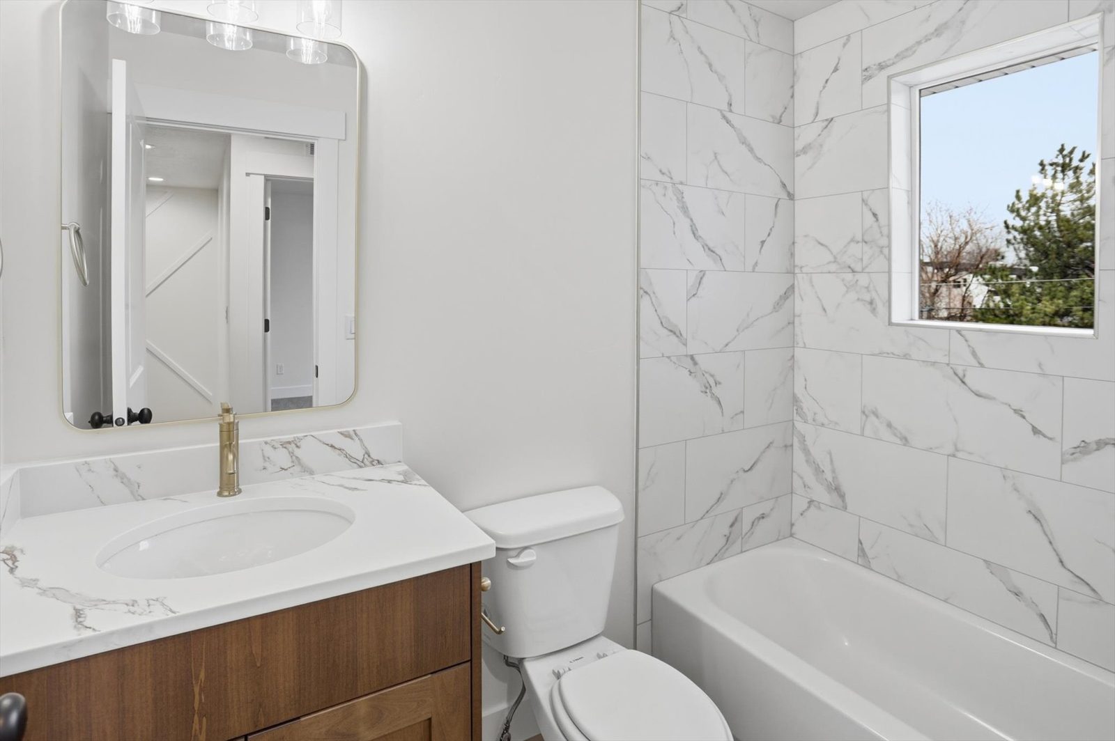 Marble-tile bath with brass fixtures